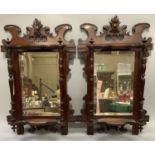 A pair of Victorian mahogany mirror back wall shelves with slender turned uprights