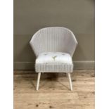 A white Lloyd Loom tub chair