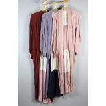 Three summer-weight Japanese kimonos in differing shades and fabrics, two in pastel shades,