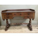A Victorian mahogany washstand having a three quarter raised back over a drawer and kneehole flanked