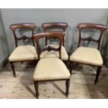 A set of four Victorian mahogany dining chairs with foliate tie rails and on inverted tulip