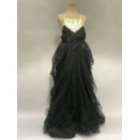 A 1950’s net ballgown, labelled “Julian Rose, London”, with voluminous layered skirts, the net