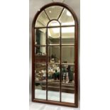 A modern mahogany panelled wall mirror of arched outline , 169cm high x 81cm wide