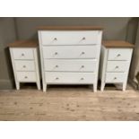 A cream and wood effect chest of four drawers and pair of three height bedside chests on styled feet