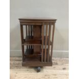 A mahogany revolving bookcase with railed panels