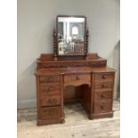 A Victorian mahogany dressing table having a raised back and rectangular mirror on barleytwist