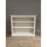 A set of cream bookshelves on plinth base, 106cm wide by 90cm high