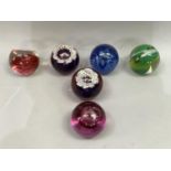 Six Caithness glass paperweights including Mischief, Sorcerer's Apprentice, Fireball, Celebration