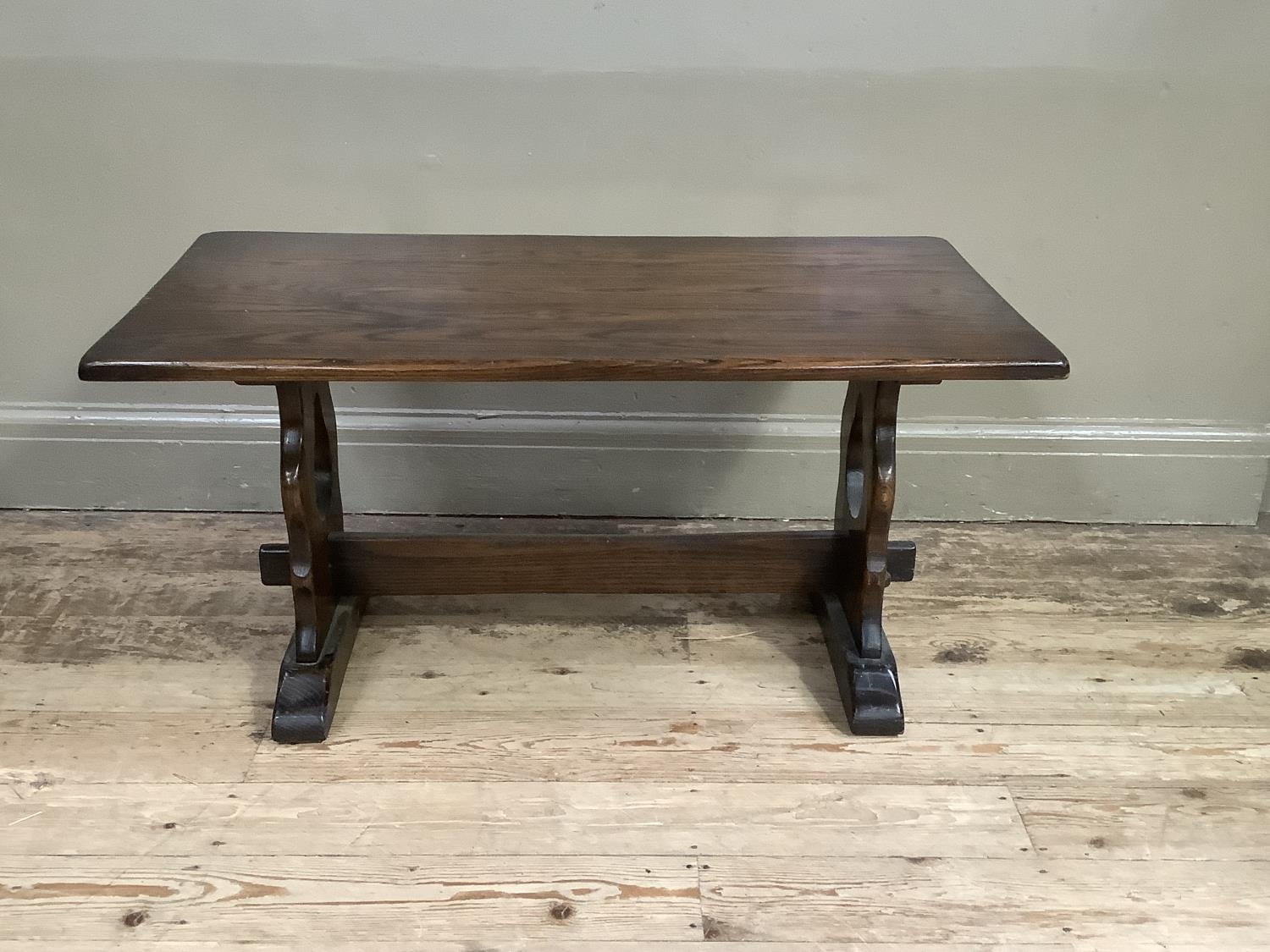 An oak coffee table on refectory supports, 90cm wide
