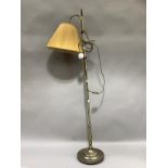A gilt metal adjustable reading lamp on circular base