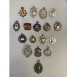 A collection of 16 early 20th century silver medallions and badges including ARP, Masonic and