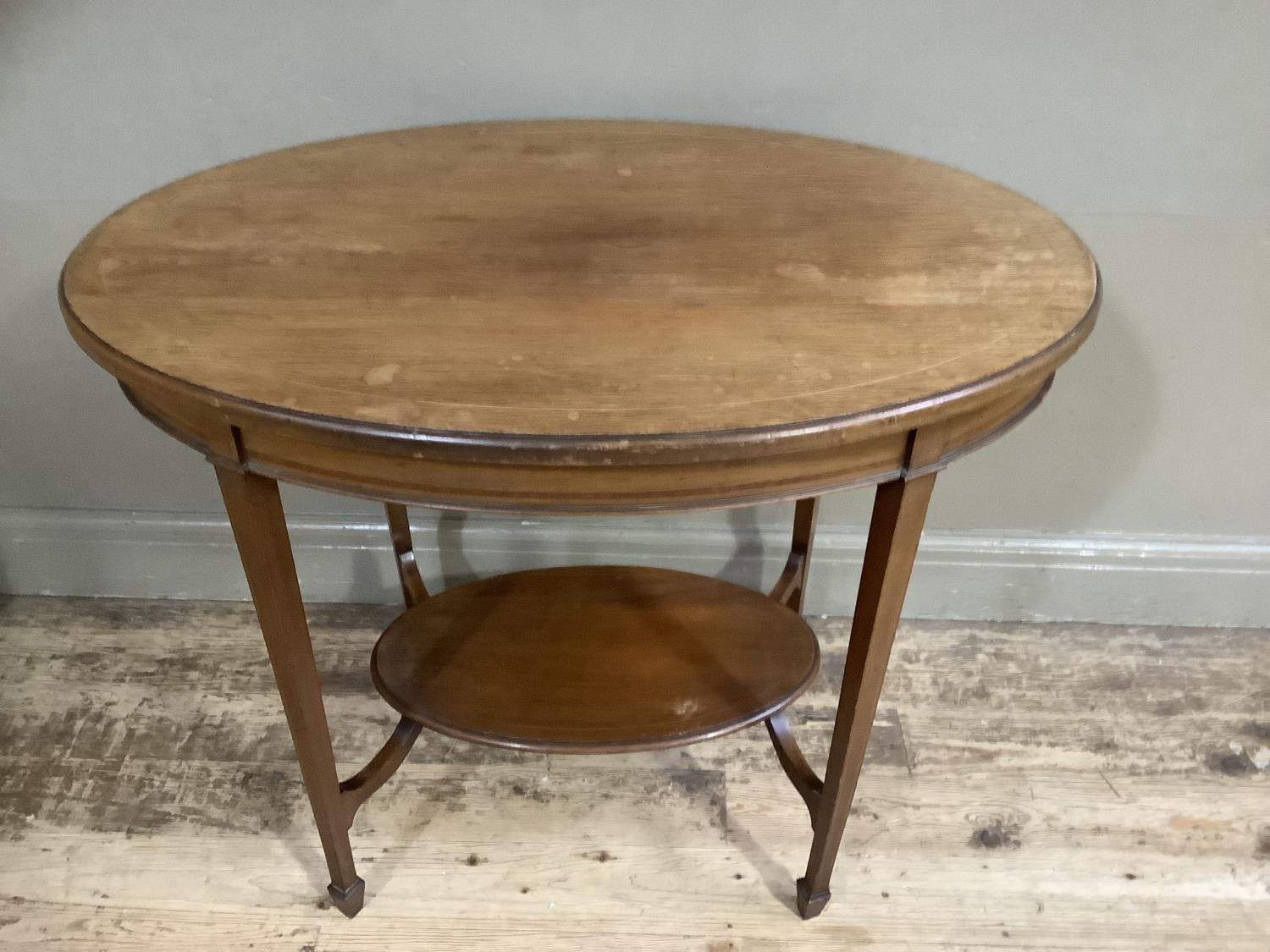 An Edwardian mahogany window table of oval outline on square tapered legs joined by an under tier - Image 2 of 2