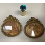A pair of gilt metal oval frames with rocaille foliate and 'C' scroll cresting each containing a