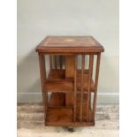 A reproduction Edwardian mahogany and inlaid revolving book stand, 47cm by 86cm high