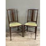 A pair of polished beech bedroom chairs with splat and rail backs on rounded legs