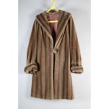 A 1950’s shaded beige coat, faux fur, with shawl collar, labelled for “Nylaska fabric”, single