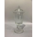 A glass goblet shaped vase and domed cover etched with a continuous scene of a town with four