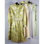 A lime green short dress woven with fold threads in a floral design, most likely sari fabric; a