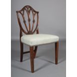 An 18th century mahogany single chair, the open shield shape back carved with anthemion, pendant