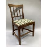 An early 19th century mahogany single chair with rail back and upholstered seat and on square