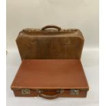 A large Gladstone bag together with a small leather suitcase