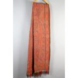 A mid-19th century paisley Long Shawl in shades of red and orange, 314cm x158cm