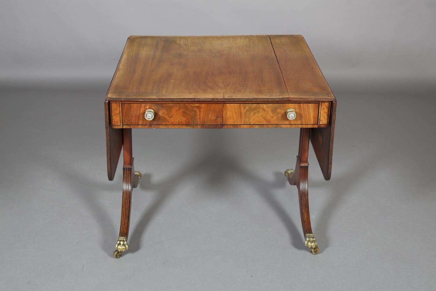 A Regency Mohogany and Rosewood crossbanded sofa table with ebony stringing, having a drawer and