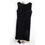 An elegant black panne velvet sleeveless and waisted evening dress, the hem finished with a panel of