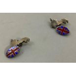 A pair of silver and enamel cufflinks, each with an outline of Great Britain and on an oval red