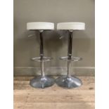 A pair of chrome pedestal breakfast stools