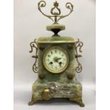 A late 19th century onyx and gilt metal mounted mantel clock, having a cream dial with black