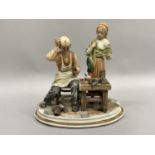 A Capodimonte style group of a cobbler and his daughter, 28cm high together with a 20th century