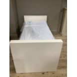 A contemporary cream finish single bed with pull out second mattress and with floral upholstered