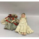 A Victorian wax head and shoulder doll with blue glass eyes and blonde hair, composition limbs and