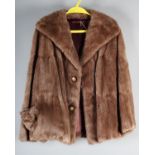 A short fur jacket, possibly mink, and matching cap, lined, no label