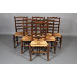 A SET OF SIX 19TH CENTURY ELM WAVY LADDER BACK SINGLE CHAIRS, rush seated, on turned legs and
