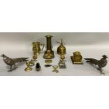 A pair of white metal cock and hen pheasants, brass shell casing, chamber stick, mug, oil can,