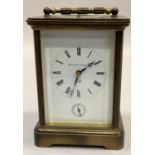 A carriage strike alarm clock by Matthew Norman in a brass case with five bevelled glass panels