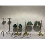 A pair of brass adjustable reading lamps on circular raised bases together with a gilt metal twin