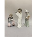 Lladro figure of an angel 22 1/2 cms high together with a girl holding 2 puppies and a girl