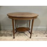 An Edwardian mahogany window table of oval outline on square tapered legs joined by an under tier