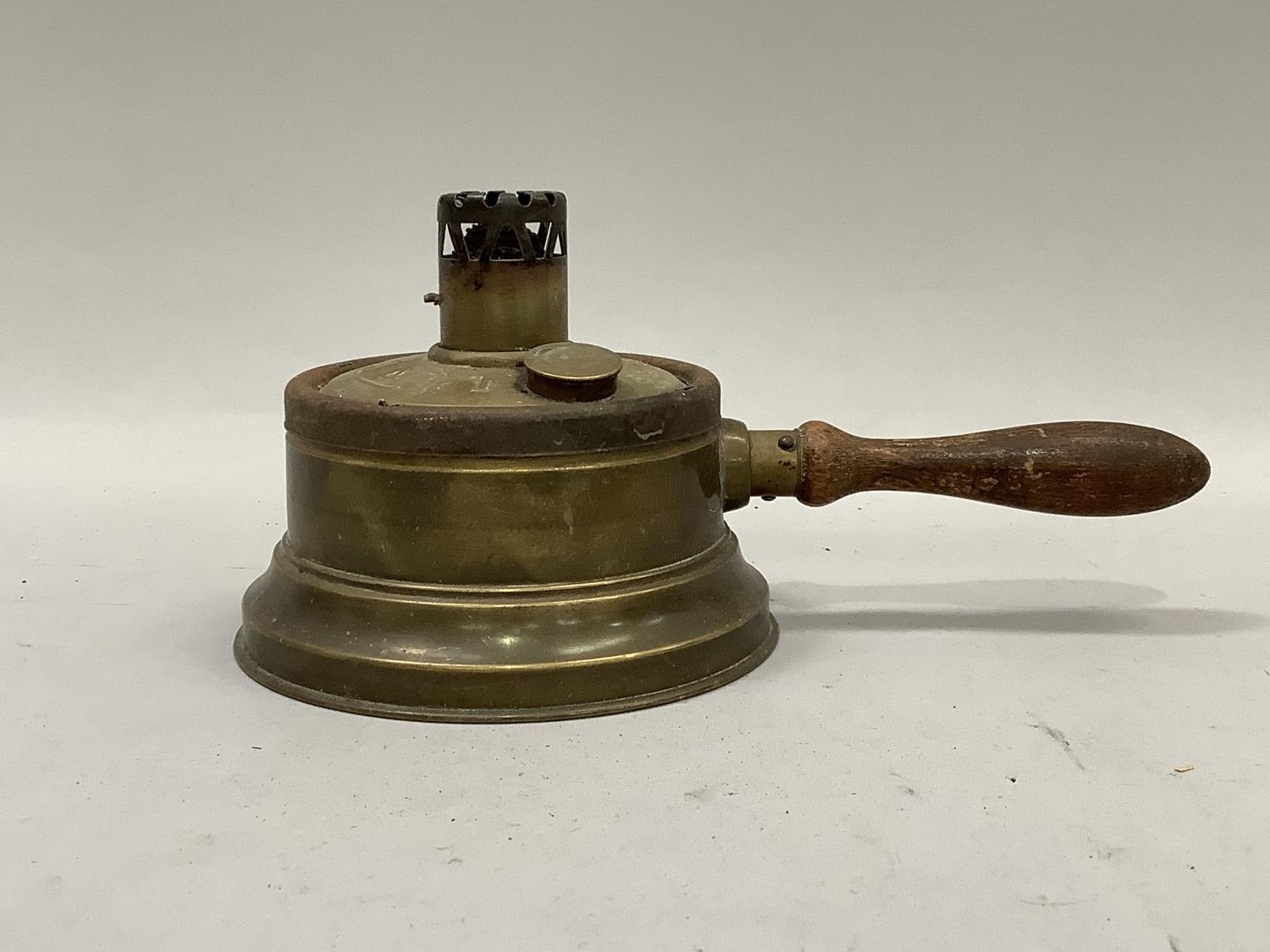 An early 20th century French brass and turned wood handled light 'L'UNIC' 13.5cm diameter without