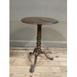 A 19th century polished beech circular table, on a tripod base with knurled feet.