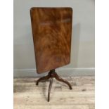 A 19th century mahogany snap top table, rectangular form on a turned column with quadruple base,