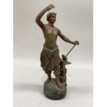 A late 19th century French bronze effect spelter figure of a blacksmith on a naturalistic base, 36cm