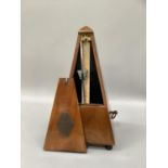 A French walnut metronome with metal plaque lettered with 'Metronome Salon Maelzel' 23 cm high.