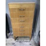 A Remploy beech veneer chest of six graduated drawers with bar handles and on square legs, 53cm wide