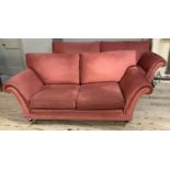 A suite of three seater sofa, two seater sofa and stool on turned legs with brass caps and