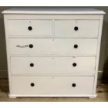An early 20th century white painted chest of two short and three long drawers, rosette and ring