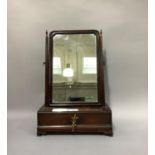 An 18th century mahogany toilet mirror, rectangular outline with moulded frame and tapered